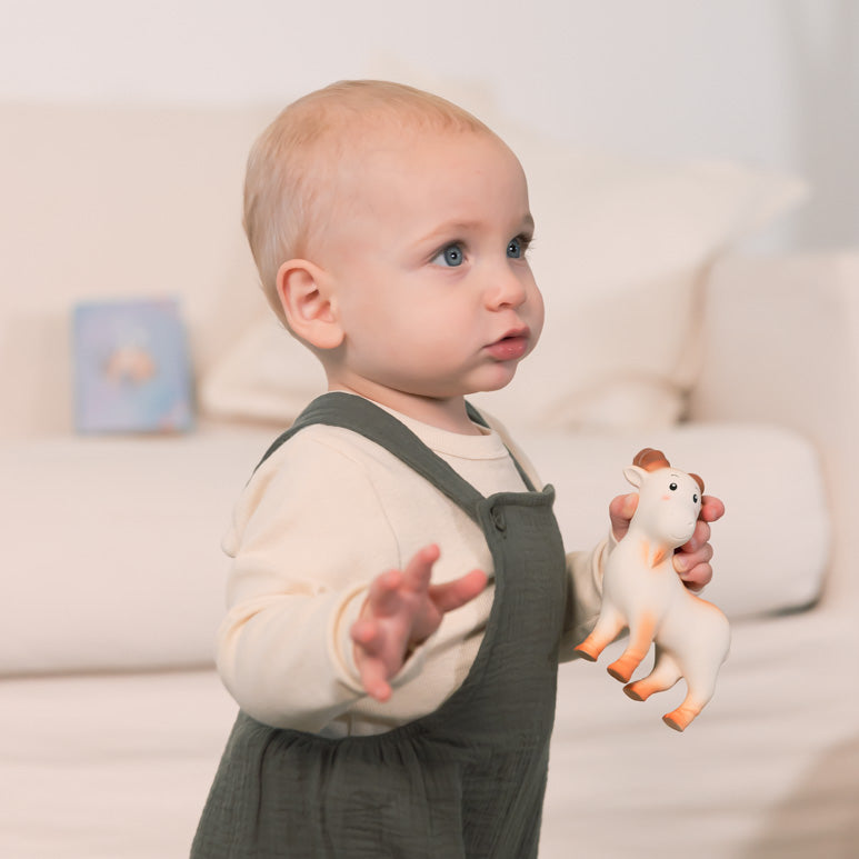 Small child with ChaBil colourful, playful, cute teething toy, Capricorn.